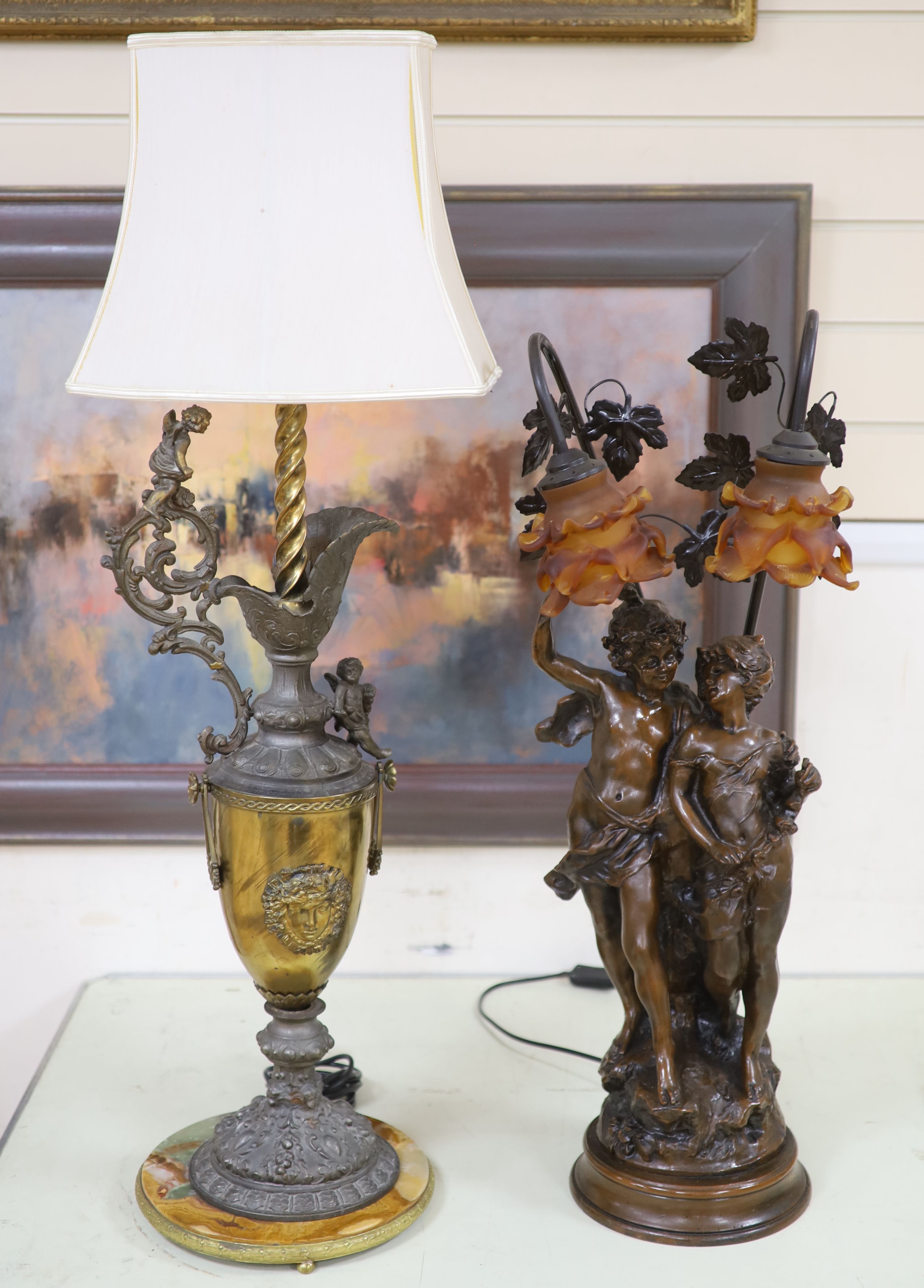 A Florentine style brass, spelter and onyx ewer shaped table lamp and a bronzed spelter figural table lamp with glass shades